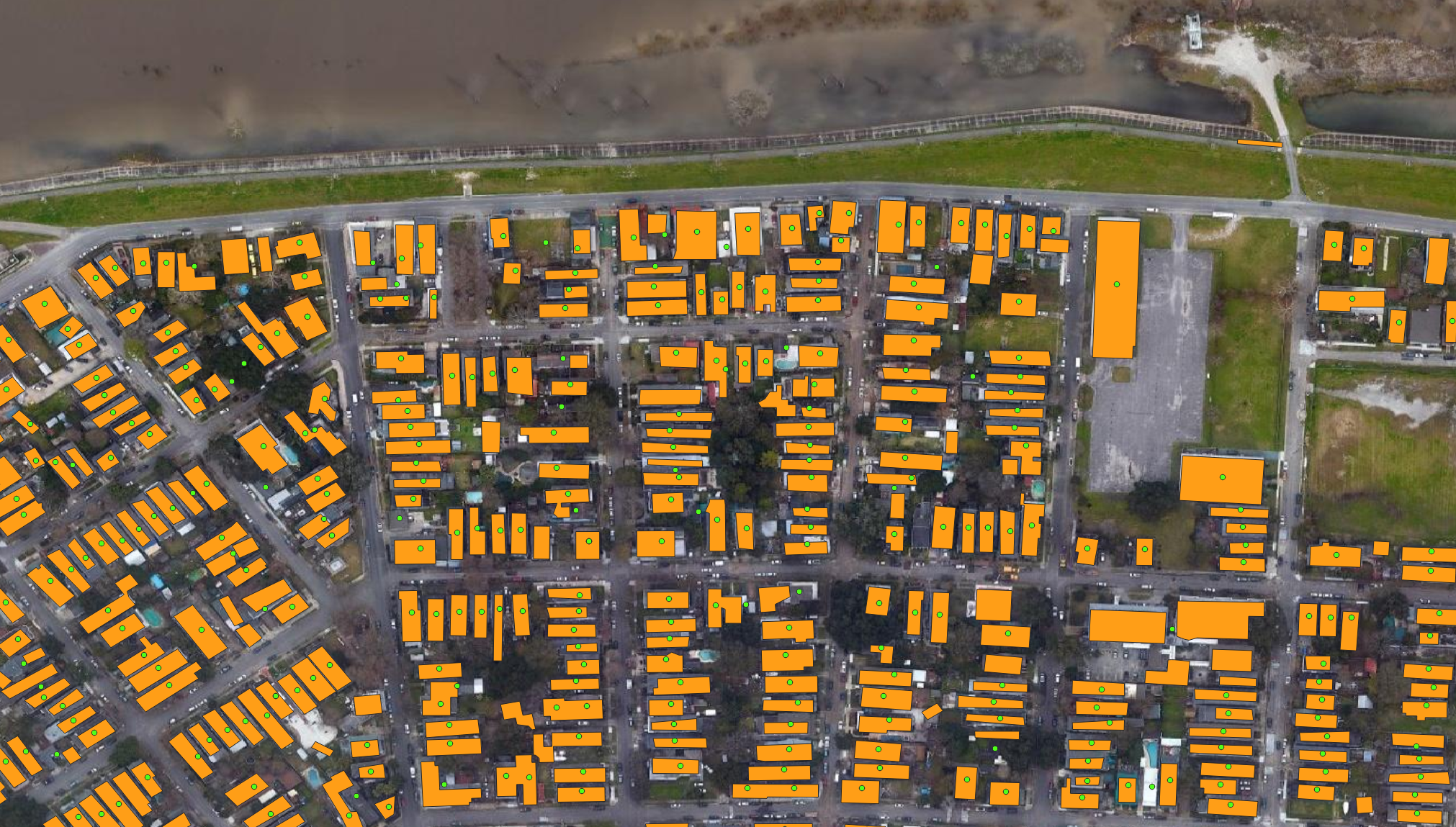 Figure 2, Example aerial map displaying FEMA's USA Structures dataset (yellow-orange polygons) and NSI points (bright-green points). 