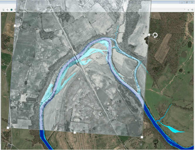 The River Analysis System (HEC-RAS) was used to simulate river conditions for a range of flows. Model results (blue, with shallower areas as lighter blues, 6,000 cfs) were compared to aerial photographs (semi-transparent gray tones, 1964, during flows of 5,900 cfs) to investigate channel and floodplain features that constrain release of high flows from Barren River Dam. Image shows Barren River roughly 13 miles below dam.