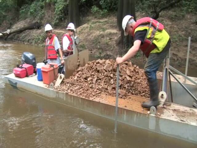 Environmental flows are used to help flush fine sediments. Gravels are placed to establish a gravel bed in Big Cypress Bayou for Paddlefish spawning habitat.