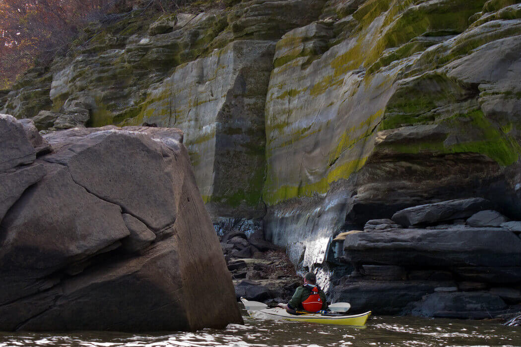 Kayaker explores bluffs along the shoreline of Lake Red Rock, a reservoir located about 50 miles downstream of Des Moines, Iowa. Lake Red Rock is operated for flood risk management as well as recreation, water supply, and fish and wildlife.