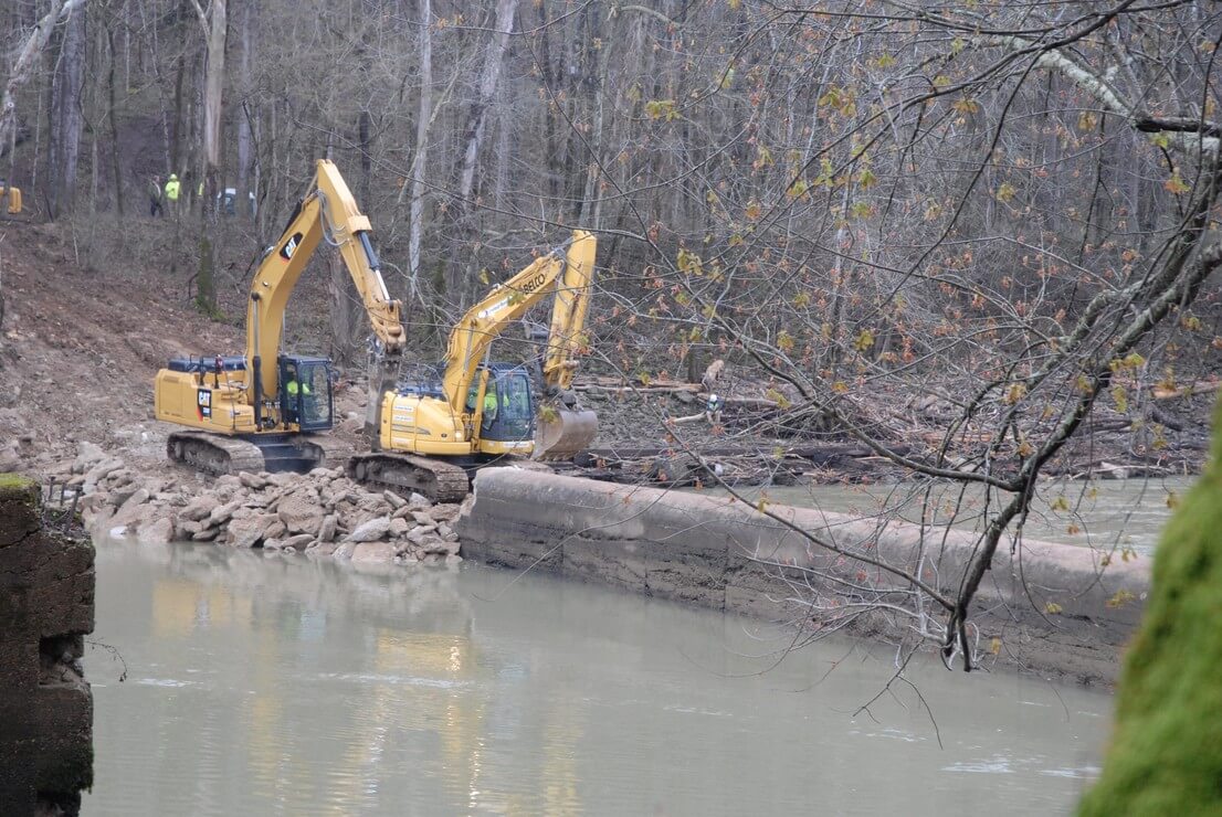 Excavators break up Green River Lock and Dam No. 6 during demolition, which was completed in April 2017.