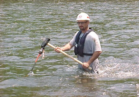 A USACE Philadelphia District Ecologist installing water quality monitoring equipment in the Lehigh River.